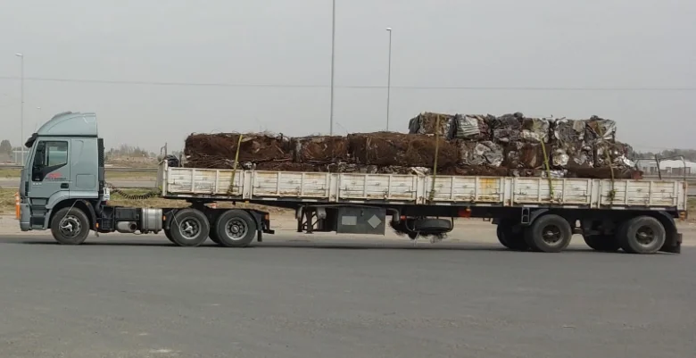 Camión con acoplado transportando chatarra por ruta
